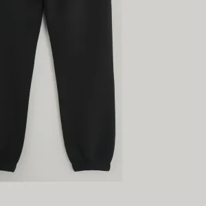Front view of black joggers/sweatpants showing the adjustable drawstring waist and side pockets.