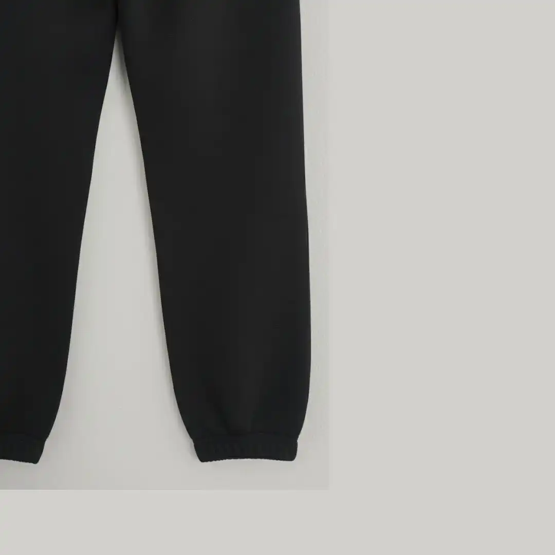 Front view of black joggers/sweatpants showing the adjustable drawstring waist and side pockets. Front view of black joggers/sweatpants showing the adjustable drawstring waist and side pockets.