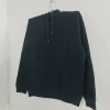 A plain black pullover hoodie with a drawstring hood and a large front kangaroo pocket, photographed on a hanger.
