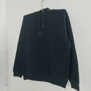 A plain black pullover hoodie with a drawstring hood and a large front kangaroo pocket, photographed on a hanger.