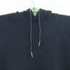 A plain black pullover hoodie with a drawstring hood and a large front kangaroo pocket, photographed on a hanger.