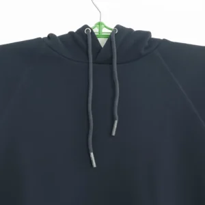 A plain black pullover hoodie with a drawstring hood and a large front kangaroo pocket, photographed on a hanger.