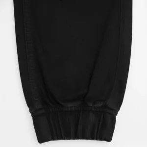 Image of CROPP black jogger pants with elastic waist, folded and showing the size 36 JOGGER tag.