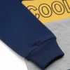 Front view of a navy blue, yellow, and grey long-sleeve kids' sweatshirt with a diagonal yellow block that reads 