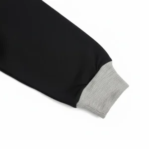 Front view of a black, yellow, and grey long-sleeve kids' sweatshirt with a diagonal yellow block that reads