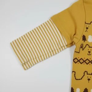 Front view of a mustard yellow toddler long-sleeve T-shirt with a white collar, featuring rows of bears, reindeer, snowmen, and trees print, and yellow-and-white striped sleeves with a layered look.