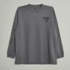 men’s charcoal gray long-sleeve crew neck t-shirt featuring a small black chest graphic and printed branding on the left sleeve.