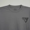 men’s charcoal gray long-sleeve crew neck t-shirt featuring a small black chest graphic and printed branding on the left sleeve.