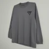men’s charcoal gray long-sleeve crew neck t-shirt featuring a small black chest graphic and printed branding on the left sleeve.