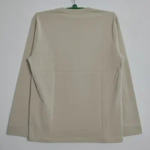 Beige men’s long-sleeve crew neck t-shirt featuring a small mont-bell logo on the chest, displayed on a plain background.