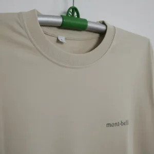 Beige men’s long-sleeve crew neck t-shirt featuring a small mont-bell logo on the chest, displayed on a plain background.