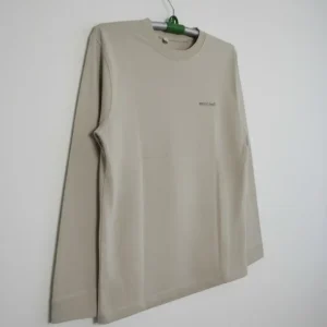 Beige men’s long-sleeve crew neck t-shirt featuring a small mont-bell logo on the chest, displayed on a plain background.