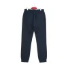 Back view of dark navy blue tapered joggers/chinos showing the cuffed ankles and sleek back welt pockets.