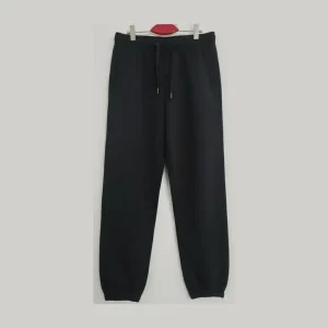 Front view of black joggers/sweatpants showing the adjustable drawstring waist and side pockets.