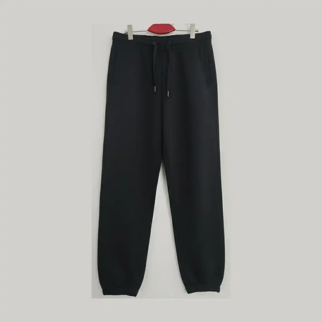 Front view of black joggers/sweatpants showing the adjustable drawstring waist and side pockets. Front view of black joggers/sweatpants showing the adjustable drawstring waist and side pockets.