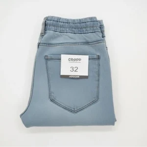 Full product shot of CROPP light blue denim joggers with drawstring waist and cuffed ankles, shown hanging.
