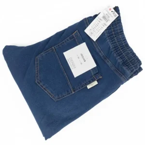 Image of dark indigo blue denim joggers, folded, showing the elastic waistband, back pocket, and DENIM JOGGER tag.