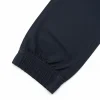 Image of folded Nautica navy blue joggers, highlighting the elastic waistband, rear slit pocket.