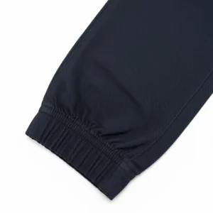 Image of folded Nautica navy blue joggers, highlighting the elastic waistband, rear slit pocket.