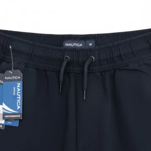 Image of folded Nautica navy blue joggers, highlighting the elastic waistband, rear slit pocket.