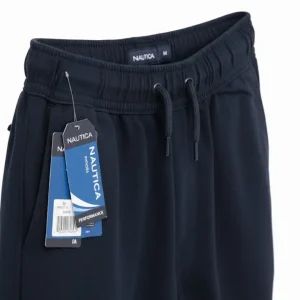 Image of folded Nautica navy blue joggers, highlighting the elastic waistband, rear slit pocket.