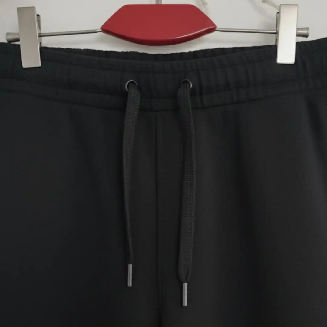 Front view of black joggers/sweatpants showing the adjustable drawstring waist and side pockets. Front view of black joggers/sweatpants showing the adjustable drawstring waist and side pockets.