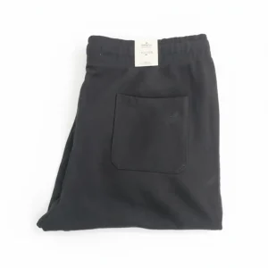 Back view of black drawstring joggers/sweatpants showing the rear patch pocket and elastic cuffs.