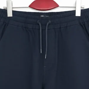 Front view of dark navy blue tapered joggers/chinos showing the drawstring waist and slanted side pockets.